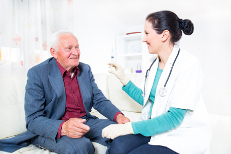 doctor making blood test for senior man