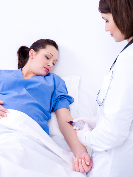 doctor takes blood on the analysis from a vein from the pregnant woman