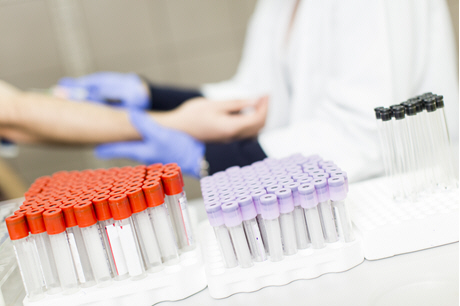 doctor takes blood sample from patient