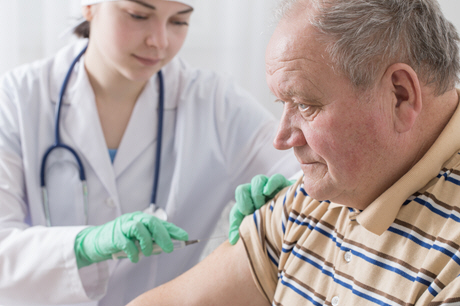 elderly man gives blood sample to nurse