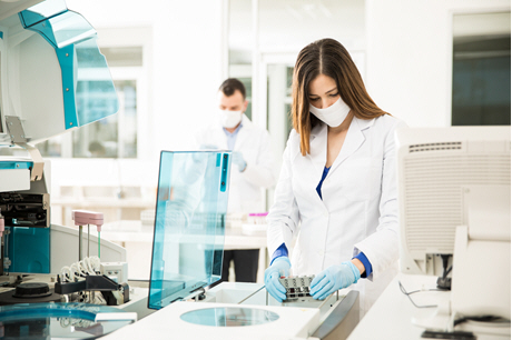 female doctor analyzing blood samples in lab