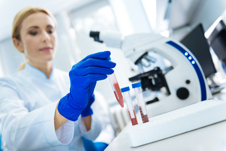 female doctor doing analysis with microscope