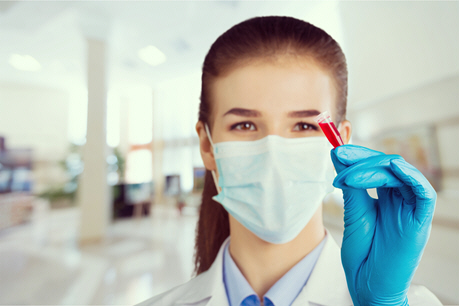 female doctor examines small blood sample
