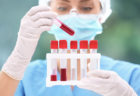 female doctor takes a look at blood sample