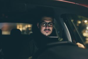 graphicstock young handsome man using smartphone in his car at night dangerous technology driver concept_H6lLjnNc1  300x200