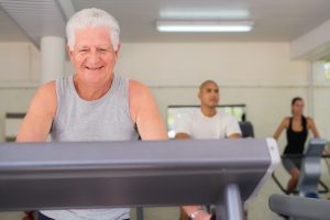 people and sports elderly man working out on treadmill in fitness gym among young peop SBI 310156706 300x200