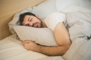 Man sleeping in a bed.