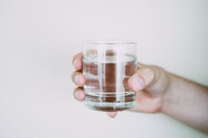 Person holding a drinking glass